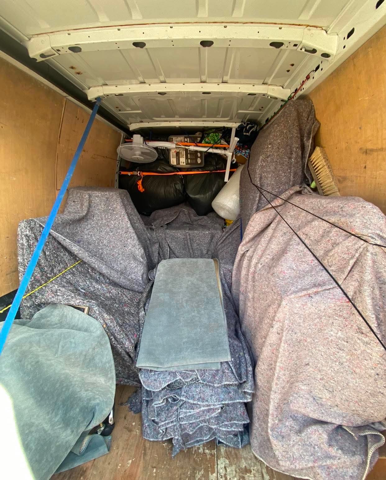 Neatly packed removal van full of protected furniture